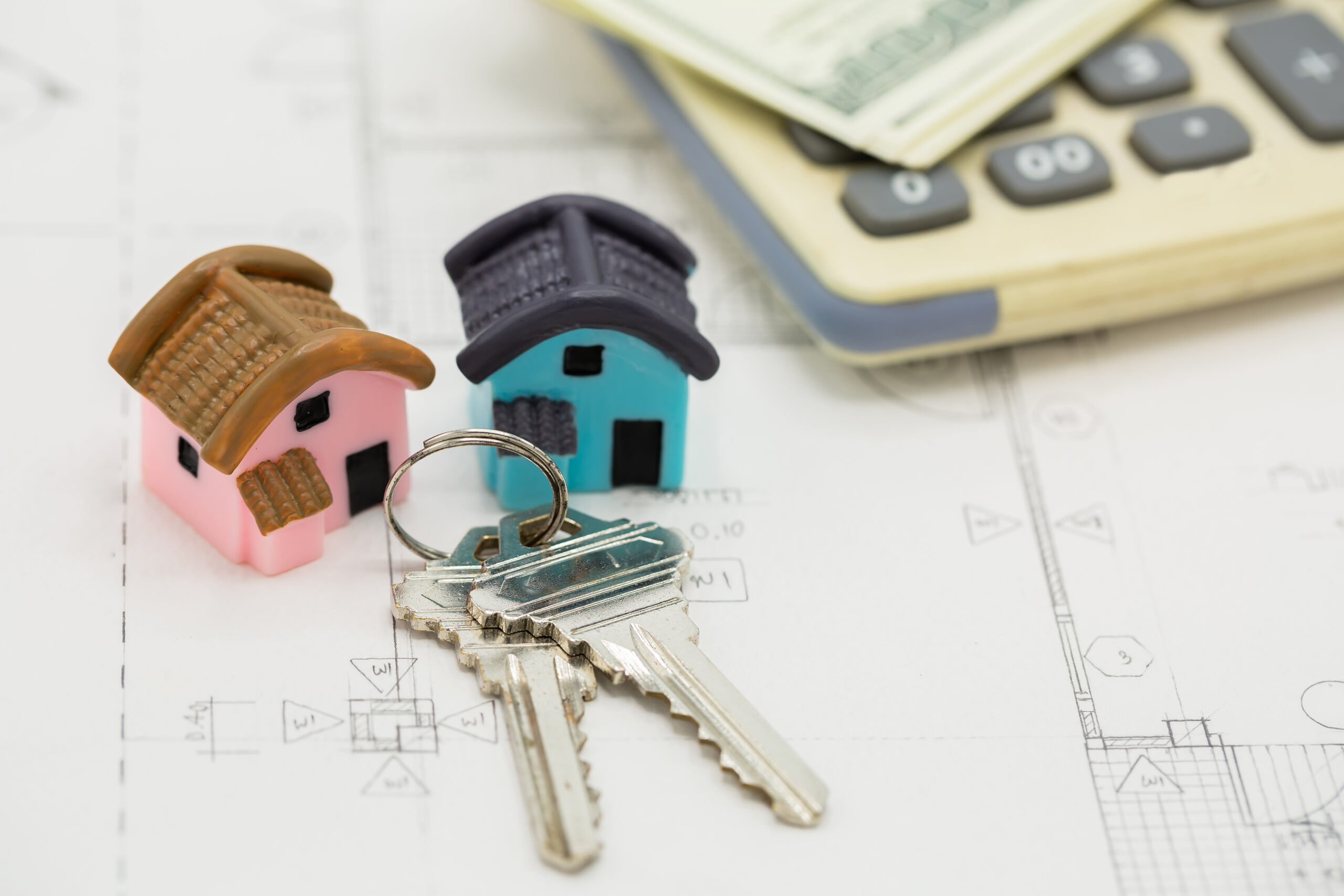 house key calculator with dollar bills