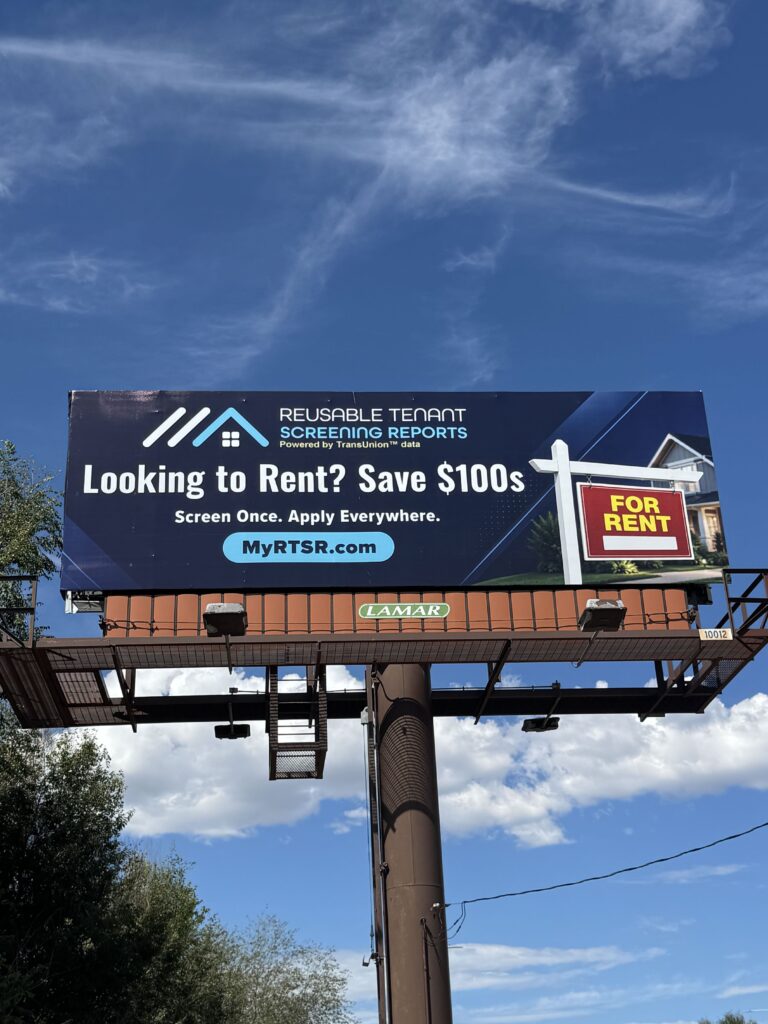 Billboard advertising tenant screening services against a blue sky, with the message 'Looking to Rent? Save 0s' and a 'For Rent' panel nearby.